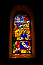 Stained glass window. The announcement by the archangel Gabriel to Mary.