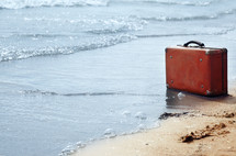 old suitcase on a beach 