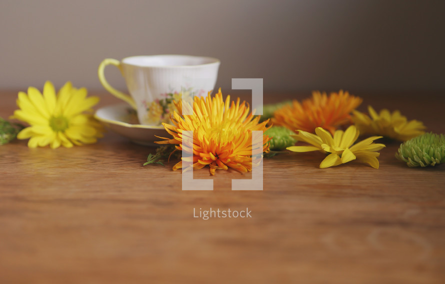 a cup of tea on table with flowers