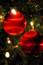 Red satin Christmas tree ornaments.