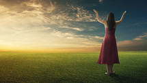 woman with her hands raised in praise and worship to God