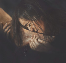 Woman crying tears on feet of Jesus