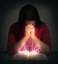synapses sparking as a woman reads a Bible 