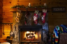 Christmas stocking hanging over a fireplace in a cabin 
