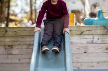 boy going down a slide 