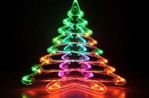 Close up of a vibrant neon Christmas tree with a reflective surface, creating a symmetrical light pattern
