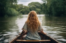 Close up of a young woman in a boat, viewed from behind