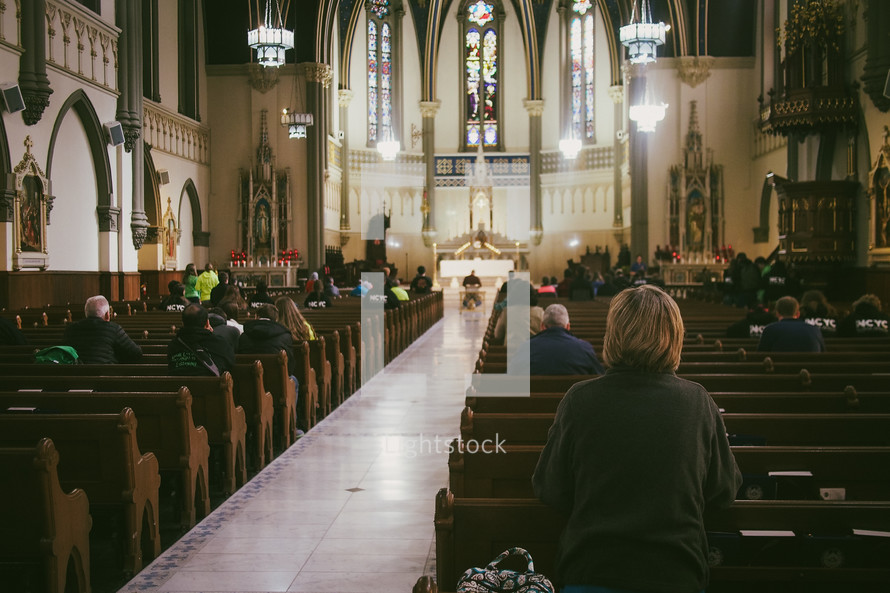 A woman praying during mass at a Catholic church