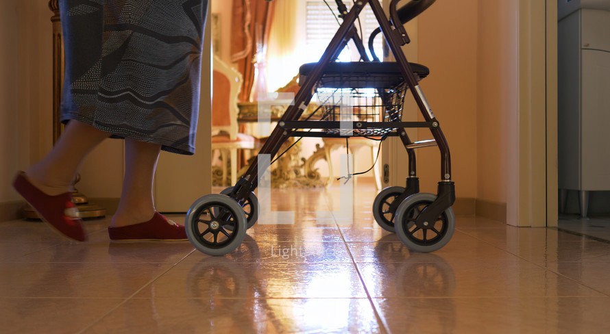 an elderly woman using a walker 