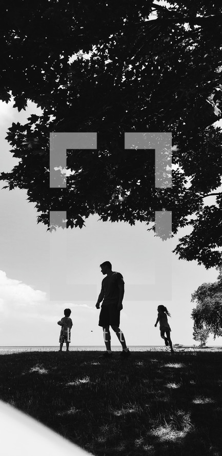 silhouettes of a father and his children 