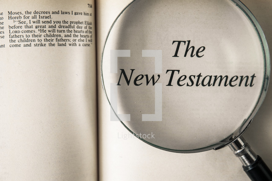 magnifying glass over Bible -The New Testament 