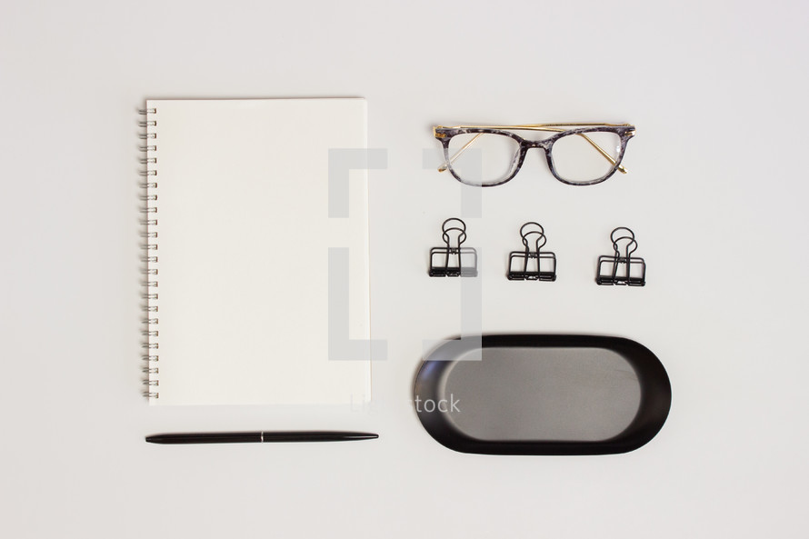 glasses and notebook on a desk 