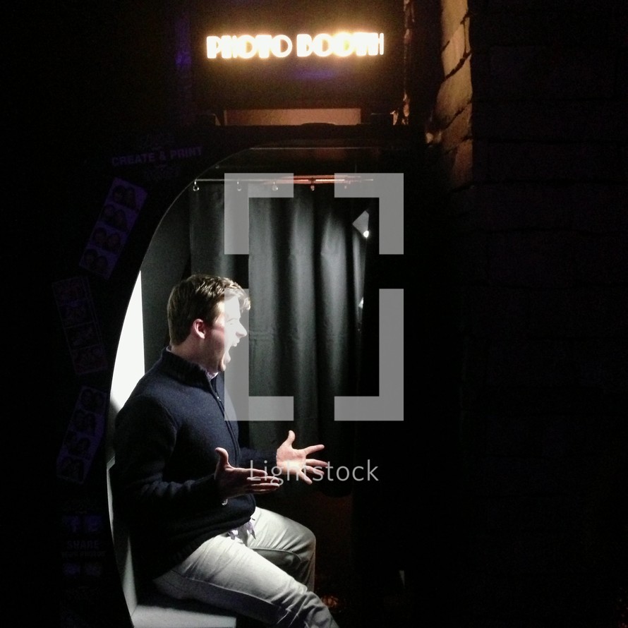 A man in a photo booth. 