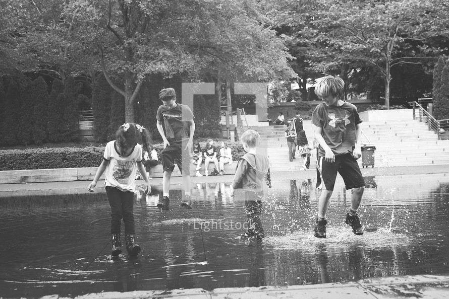 kids splashing in a puddle 