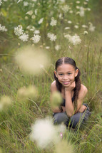 a girl in a field of wildflowers 