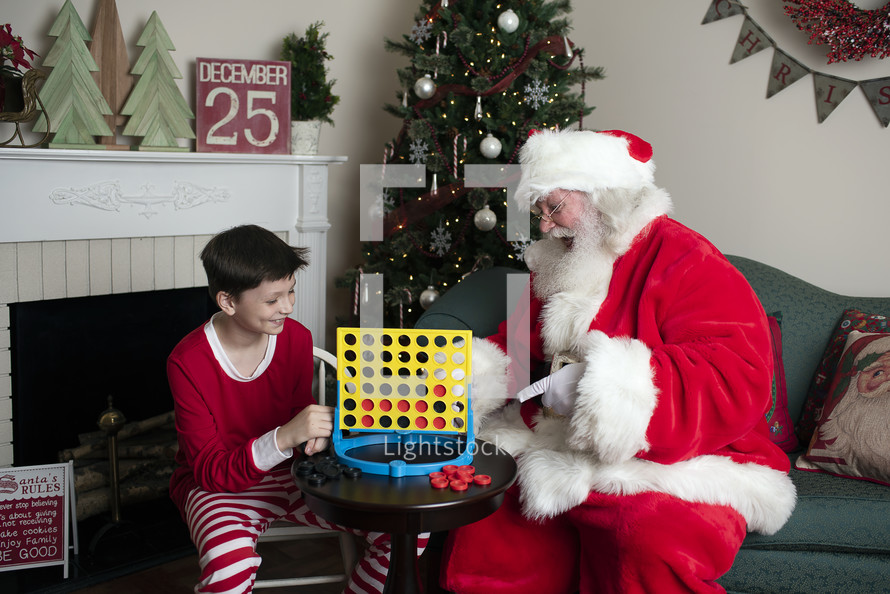 Santa and a boy playing connect four 