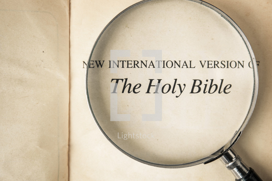 The Holy Bible title page under a magnifying glass 