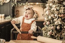 happy baby at Christmas in a highchair 