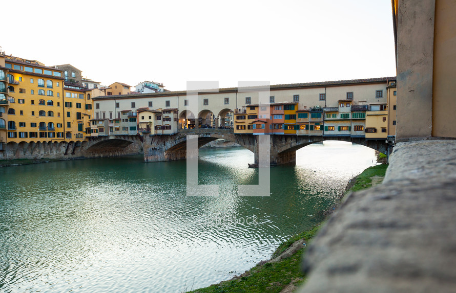Beautiful view of famous Ponte Vecchio with river Arno at sunset