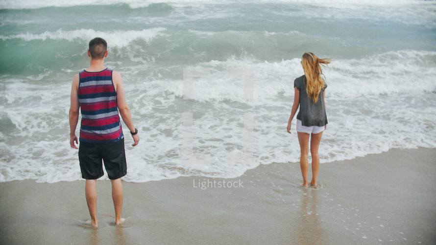 couple standing on a shore 