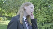 Senior school girl walking to school listening to music themes of music technology routines education