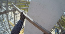 POV shot on a construction worker working on scaffold in a construction site.