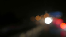 bokeh lights from taillights at night and wet windows 