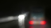 vehicle traveling on a wet road at night 