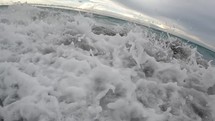 Closeup of waves crashing on shore