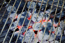Lighted charcoal for outdoor cooking.