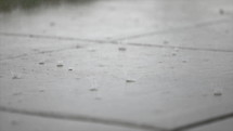 raindrops hitting the sidewalk 