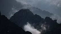 Misty atmospheric clouds in rocky Alps of Switzerland