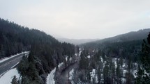 aerial view of roads through mountains with snow 