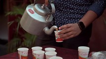 Person pouring tea in Kolkata, India