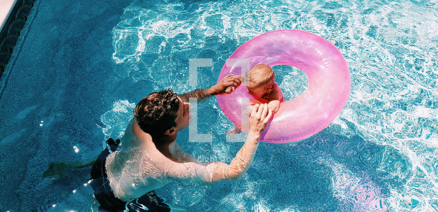father and infant in a swimming pool 