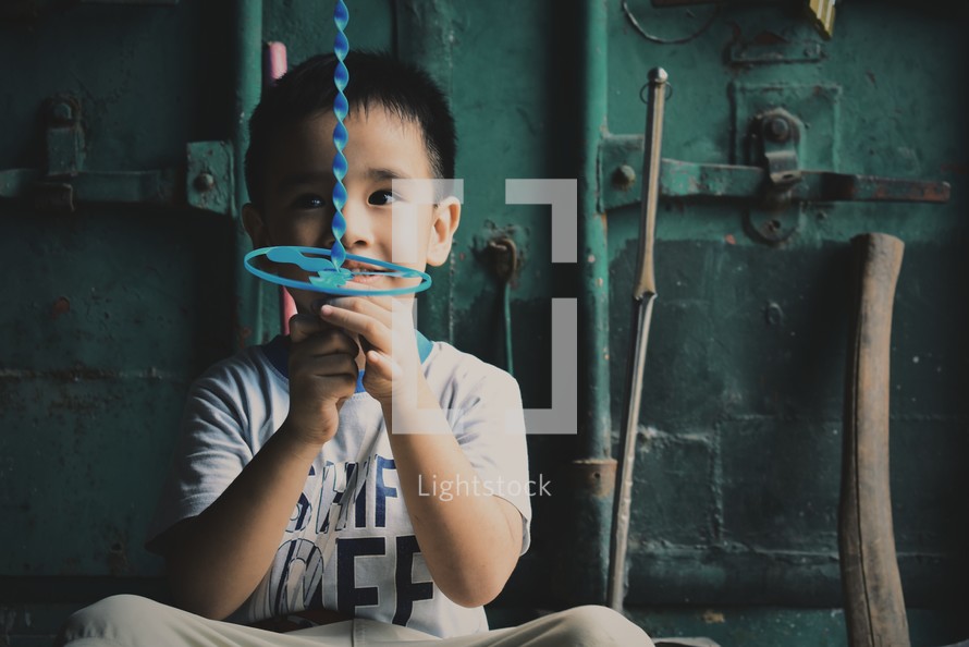a little boy holding a toy 
