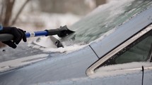 Man scraping ice from car