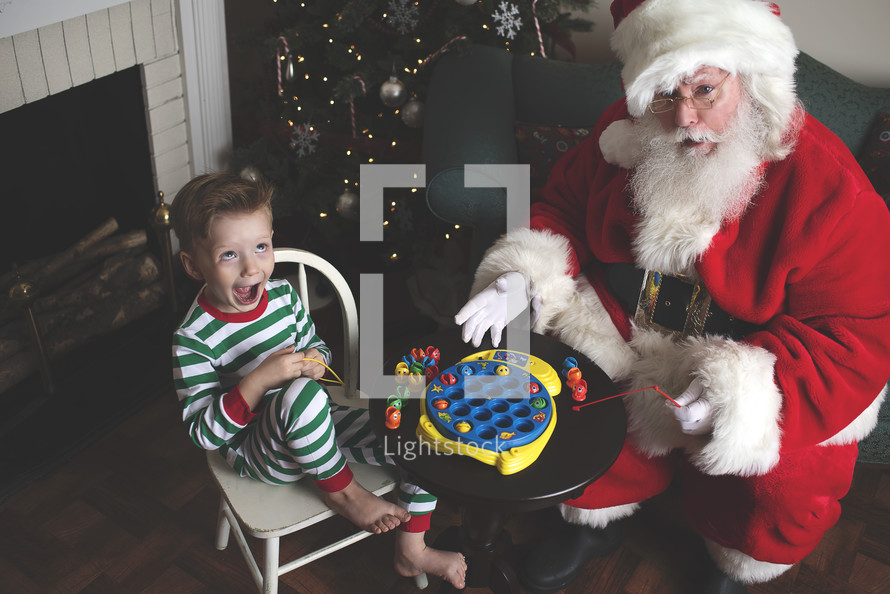 a child playing with toys with Santa 