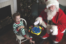a child playing with toys with Santa 