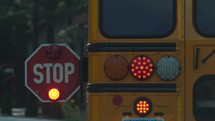 A school bus stop sign while picking up children at a bus stop