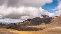 Beautiful clouds sky in sunny summer day in volcanic mountains nature in Tongariro National Park landscape in New Zealand Time-lapse
