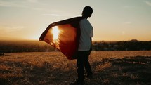 Boy with a superman cape standing outdoors 
Imagination | Dreaming | Destiny | Vision| Heroes | Justice | Kids Ministry | Movies | Heroes | Bravery | Brave | Courage | Courageous | Strong | Strength | Stand | Determination | Persevere | Sermon Series | Motion | Camera Movement | Evening | Golden Hour
