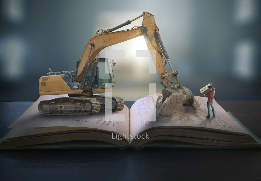 bulldozer digging into a Bible 