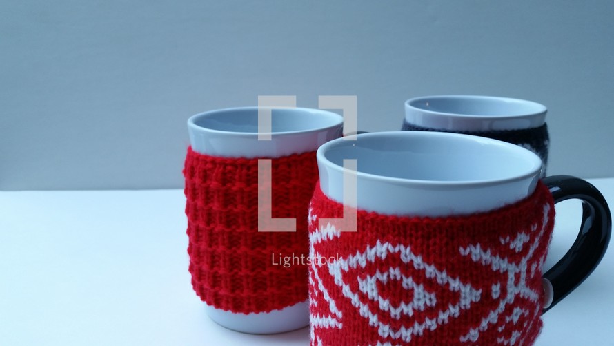 sweaters around coffee mugs 