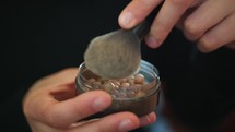 Hand Of A Woman Taking Eyeshadow With Brush