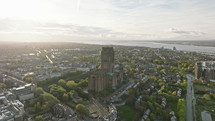 Towering cathedral amidst Liverpool's residential expanse sunset aerial