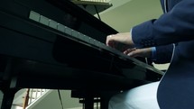a man playing a grand piano 