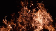 Large bonfire burning at night, slow motion flames