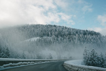 fog over snow and curve in a road 