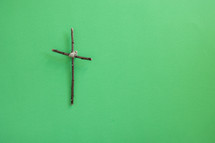 cross of sticks on green 
